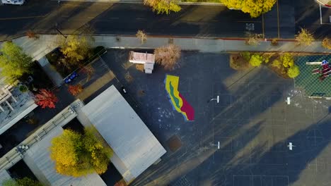 Aerial-view-above-a-Cali-mural,-on-the-streets-of-Los-Angeles,-USA---cenital,-drone-shot