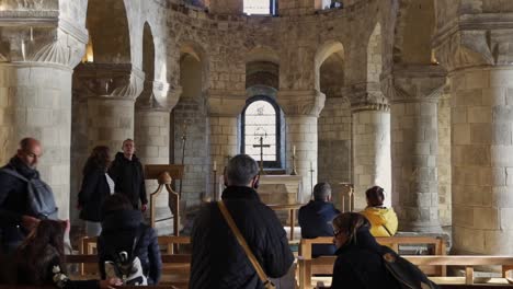 People-praying-and-taking-pictures-inside-of-romanesque-chapel-of-St-John-the-Evangelist-at-the-White-Tower-building-in-the-Tower-of-London,-England