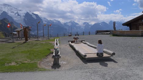 Young-kids-playing-on-a-wooden-bowling-alley-in-mannlichen,-Switzerland