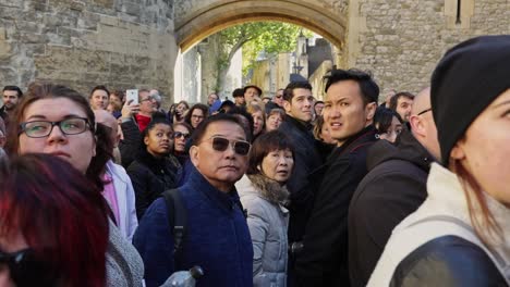 Big-group-of-tourists-turn-toward-the-camera-and-stare-amazed-during-a-tour-of-the-Tower-of-London
