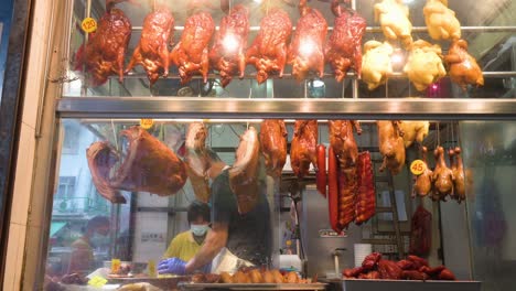 A-cook-prepares-a-meal-for-a-client-at-a-Hong-Kong-style-barbeque-food-restaurant-in-Hong-Kong