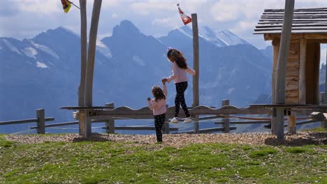 Twin-Sisters-helping-each-other-on-a-balance-beam-at-a-Swiss-park