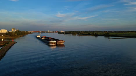 Aerial-View-Of-KVB-Roxy-Cargo-Barge-Approaching-Along-Oude-Maas-In-Late-Afternoon