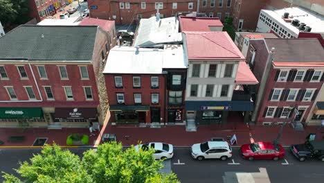 Aerial-truck-shot-of-small-businesses-and-local-cafes-along-a-quaint-suburban-street