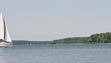 yacht-sailing-On-Kashubia-Wdzydze-Lake-In-Poland---wide,-static