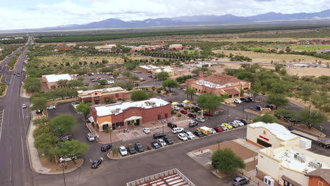 McDonalds-Restaurant-in-a-small-strip-mall-in-Southern-Arizona,-aerial-drone-approach