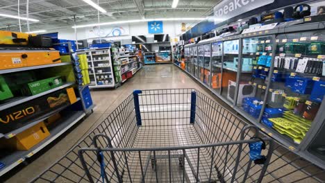 POV-while-pushing-a-cart-through-Walmart-in-electronics-section,-specifically-TVs-and-speakers