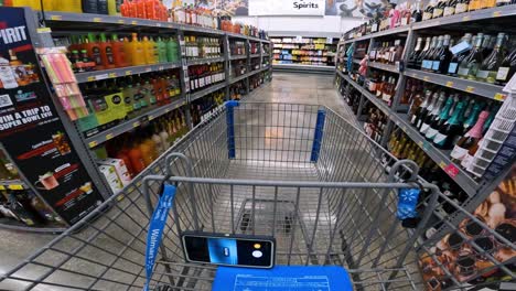 POV-while-pushing-a-cart-through-Walmart-past-the-alcoholic-beverages