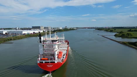 Aerial-Across-Stern-Of-A2B-Proud-Cargo-Ship-Sailing-Along-Oude-Maas-In-Zwijndrecht