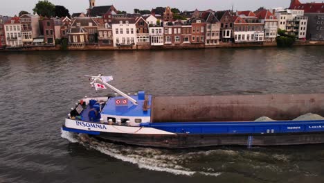 Aerial-shot-of-sand-cargo-ship-in-dutch-canal