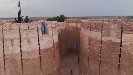 Drone-flies-backward-very-fast-and-takes-a-wide-angle-shot-of-the-entire-Umerkot-Fort-which-is-located-in-Umerkot,-Sindh,-Pakistan
