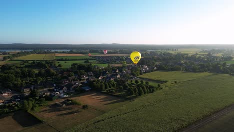 Aerial-Views-Of-Hot-Air-Balloons-Flying-During-Morning-Sunrise-Over-Rural-Countryside-In-The-Netherlands