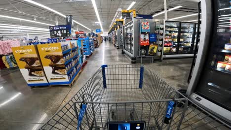 POV-while-pushing-a-cart-into-Walmart-freezer-section-from-the-main-aisle-where-cookies-and-clothes-are-visible