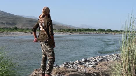 Male-Wearing-Headwrap-Standing-Beside-River-Looking-Outward-In-Balochistan,-Pakistan