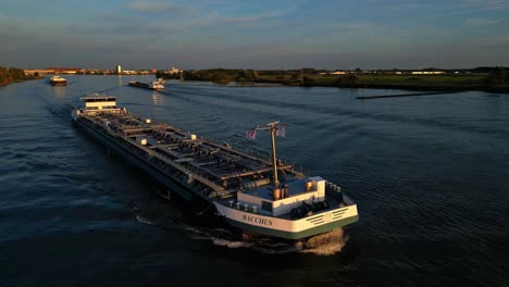Aerial-View-Of-Bacchus-Inland-Liquid-Tanker-Sailing-Along-Oude-Maas-Through-Zwijndrecht-During-Sunset