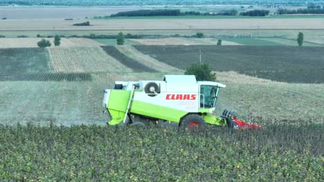 Tracking-shot-of-harvesting-Claas-Harvester-on-field-in-Germany