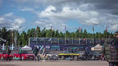 Timelapse-shot-of-crowd-walking-around-the-stadium-for-watching-RX-World-Rally-Cross-Championship-in-Riga,-Latvia-on-a-cloudy-day