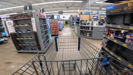 POV-while-pushing-a-cart-through-Walmart-in-the-electronics,-home-improvement-and-automotive-sections