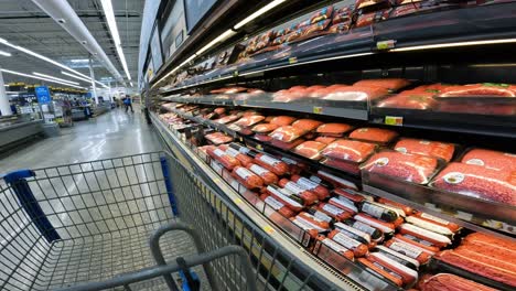 POV-while-pushing-a-cart-through-Walmart-past-the-beef-section---steaks-and-ground