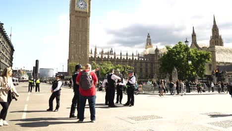 Slow-motion-shot-of-police-officers-cordoned-off-the-roads-in-Parliament-Square,-London,-UK-on-a-sunny-day