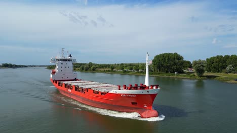 Aerial-Flying-Across-Forward-Bow-Of-A2B-Proud-Cargo-Ship-Sailing-Along-Oude-Maas-In-Zwijndrecht