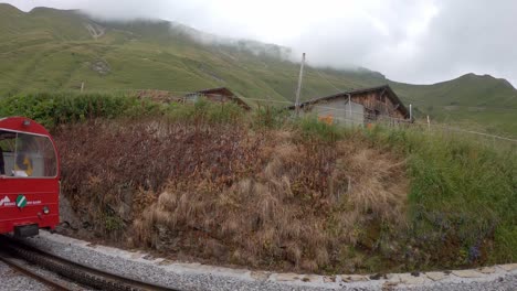 Tourists-wave-from-vintage-Brienz-Rothorn-cog-train,-Switzerland