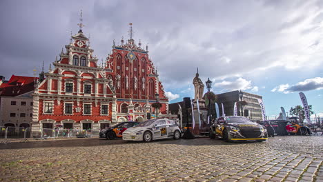 Shot-of-racing-car-parked-on-display-in-front-of-a-old-historical-building-in-Riga,-Latvia-during-RX-World-Rally-Cross-Championship-at-daytime