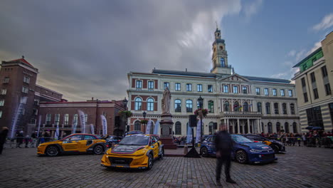 Timelapse-shot-of-racing-car-parked-in-front-of-a-old-historical-building-in-Riga,-Latvia-during-RX-World-Rally-Cross-Championship-on-a-cloudy-day