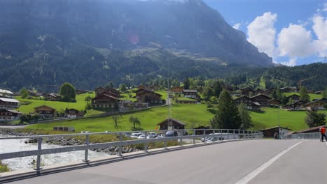 Mercedes-Benz-car-driving-over-a-bridge-in-Grindelwald,-Switzerland