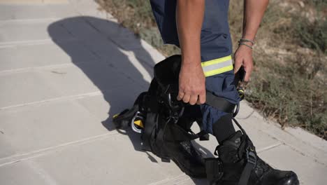 Firefighter-puts-on-safety-harness-gear-for-training-exercise