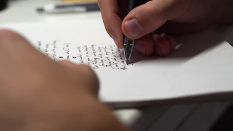 Hand-Of-A-Creative-Person-Writing-Poem-On-The-Table