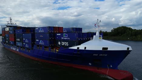 Big-ship-carrying-stacks-of-shipping-containers-on-river