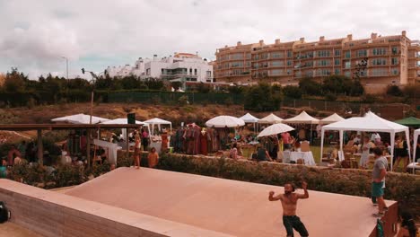 Topless-Guy-Performing-On-Skateboard-In-Nice-Resort,-Ericeira,-Portugal