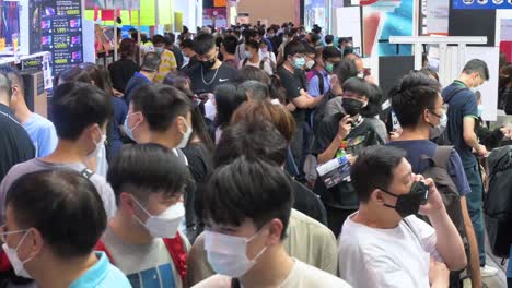 Large-crowds-of-Chinese-tech-customers-pack-the-halls-as-they-browse-and-buy-discounted-electronic-products,-such-as-hard-drives,-TVs,-and-laptops,-at-a-computer-festival