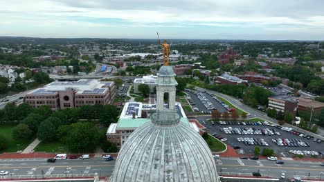 Rotational-aerial-shot-of-"The-Independent-Man"-statue-atop-Providence,-Rhode-Island-Capitol-building-dome