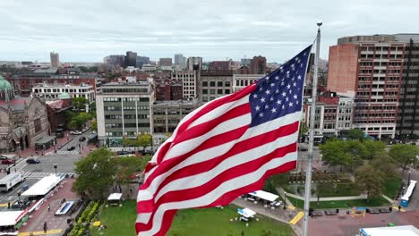 Patriotic-American-flag-waves-in-downtown-Boston