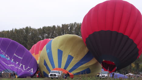 Hot-air-balloonists-inflate-their-balloons,-preparing-for-launch