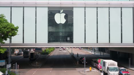 Traffic-is-seen-driving-through-an-elevated-technology-company,-Apple,-official-store-in-Hong-Kong