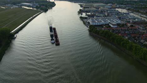 Aerial-Overheard-View-Amoureus-Push-Freighter-Sailing-Along-Beneden-Merwede-During-Sunset