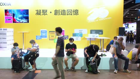 Chinese-visitors-and-retail-tech-buyers-sit-and-rest-as-they-take-a-break-during-a-Computer-and-Communications-Festival-as-shoppers-look-for-discounted-electronics-and-accessories-branded-products