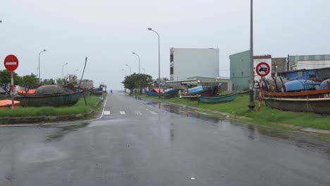Wet-Street-and-Tied-Boats,-Dark-Rainy-Day-and-Preparation-For-Incoming-Typhoon-in-Da-Nang,-Vietnam