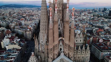 Aerial-drone-shot-of-Barcelona-with-the-great-sagrada-familia-in-Spain-with-a-beautiful-view-of-the-city-during-a-beautiful-summer-morning