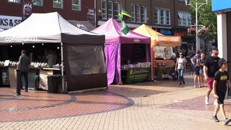 Chelmsford-High-Street-Market-stalls-and-people-walking-past,-static