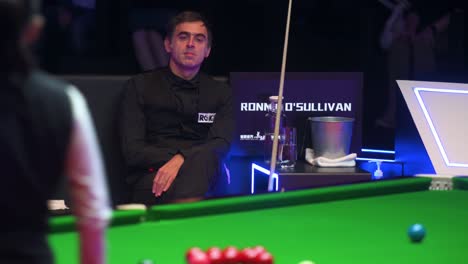 World-champion-and-world-number-one-snooker-player,-Ronnie-O'Sullivan,-looks-on-as-female-player-Ng-On-Yee-of-Hong-Kong-plays-a-shot-during-the-Hong-Kong-master-tournament-competition-event
