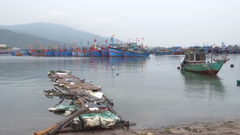 Fishing-Boats-and-Primitive-Temporary-Dock-on-Rainy-Day-During-Monsoon-Season,-Tho-Quang-Port,-Da-Nang-City,-Vietnam