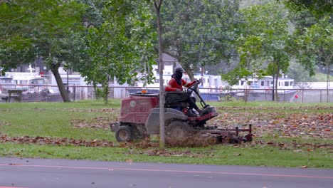 Man-Riding-Lawn-Mower-Cutting-The-Grass-In-The-Park-Near-The-Changi-Beach-In-Singapore