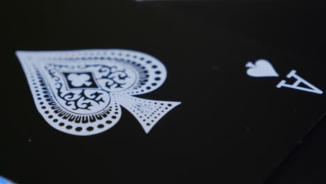 Macro-shot-of-the-ace-of-spades-of-a-black-deck-of-cards