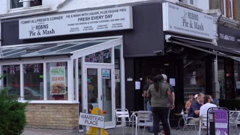 Robins-Pie-and-Mash-shop-in-Wanstead-High-Street-with-people-walking-past