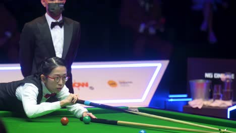 Professional-female-snooker-player-of-Hong-Kong,-Ng-On-Yee,-is-seen-in-action-as-she-strikes-a-ball-during-the-final-match-of-the-Hong-Kong-Masters-snooker-tournament-event