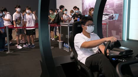 A-Chinese-gamer-plays-a-themed-racing-videogame-as-visitors-and-enthusiasts-wait-for-their-turn-during-the-Hong-Kong-Computer-and-Communications-Festival-in-Hong-Kong